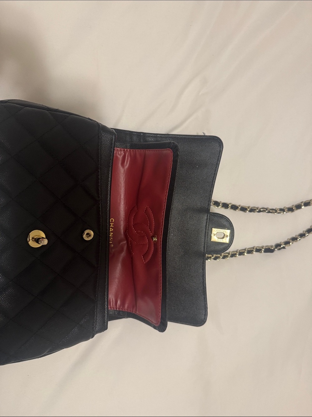 CHANEL Black Quilted Leather Shoulder Bag with Red Interior and Gold Hardware